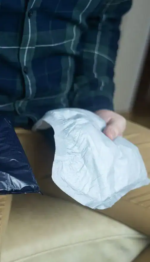 Image of man holding incontinence pads as part of overactive bladder treatment Bath