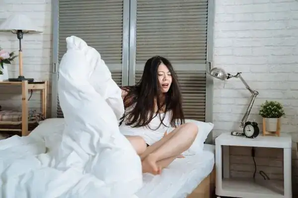 Image of woman getting up because of nighttime leaks Bath